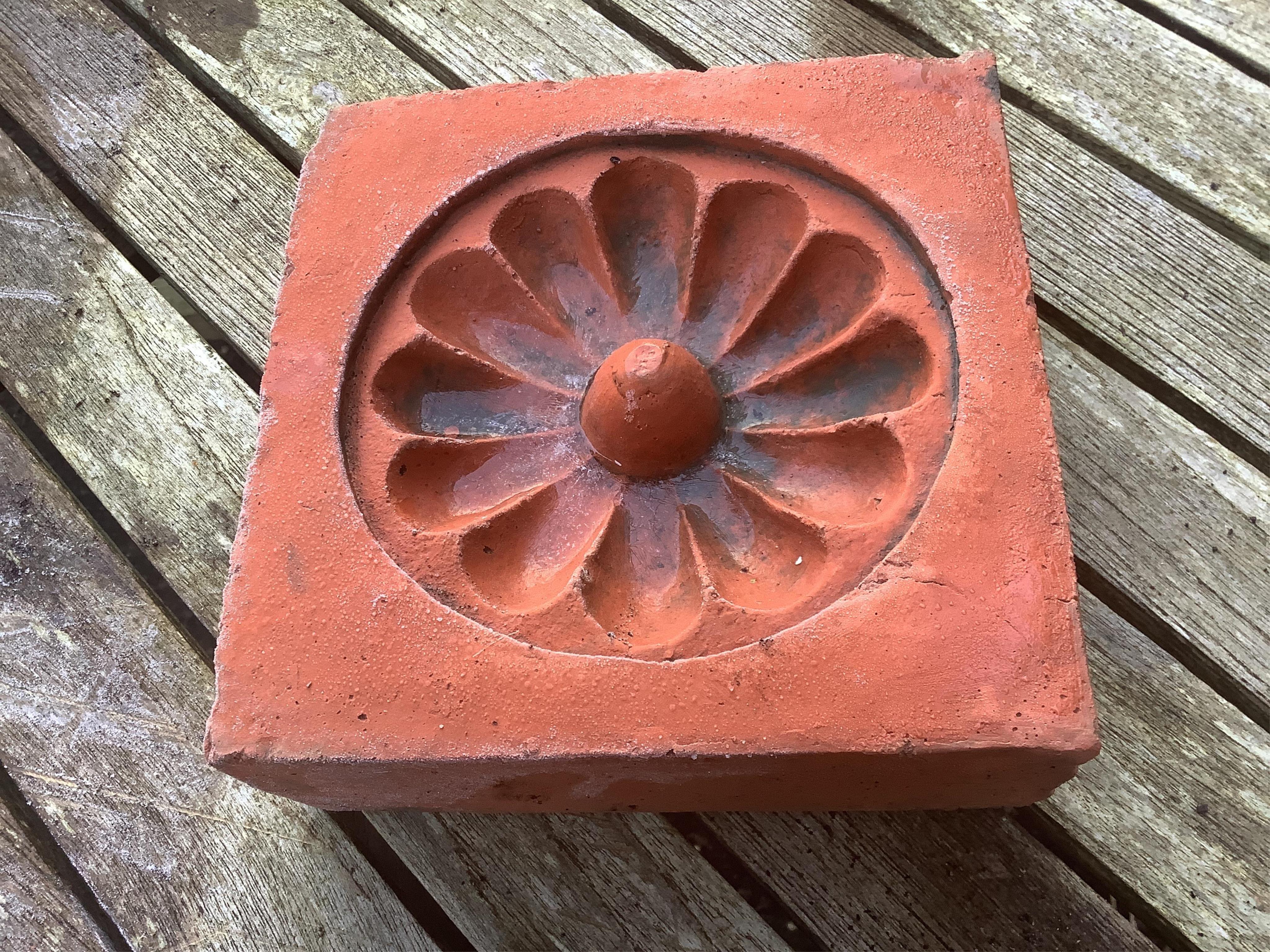 Six terracotta decorative tiles, largest width 21cm. Condition - fair